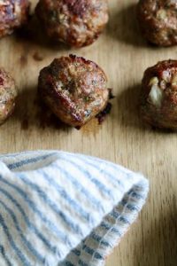cooked greek lamb meatballs on a cutting board