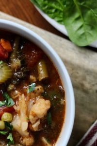 bowl of homemade vegetable soup and salad