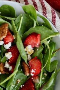 bowl of strawberry summer salad and fresh strawberries
